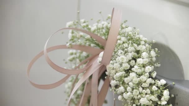 Decoratie bruiloft auto met bruiloft bloemen en satijnen linten. — Stockvideo
