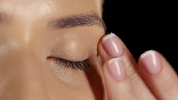 Applying foundation on the eye. Black. Closeup — Stock Video