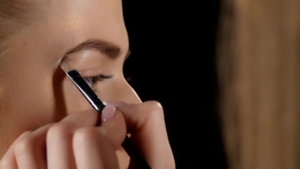 Aplicando cepillo de cejas. Maquillaje. Negro. Primer plano. — Vídeo de stock