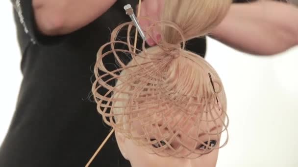 Formation of hair blonde hairstyles. Complex weave on long hair. Close up — Stock Video