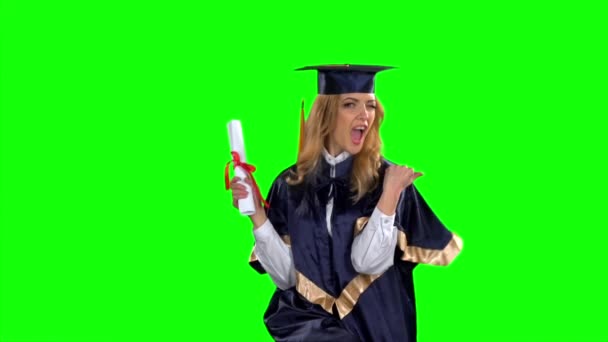 Woman in graduation gown holding diploma. Green screen. Slow motion — Stock Video