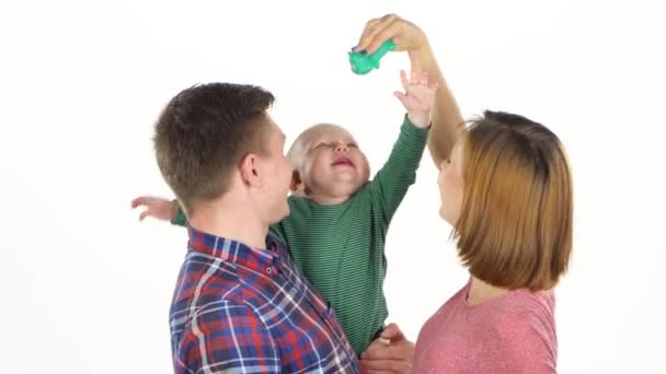 Mom, dad and child. Playing with baby. White — Stock Video