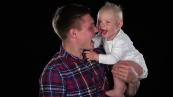 Mutter küsst zärtlich ihren niedlichen neugeborenen Sohn. schwarz — Stockvideo