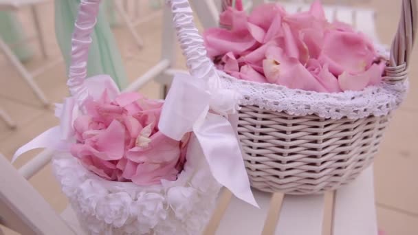 Wedding decoration. Colorful petals of roses in baskets. Close up — Stock Video