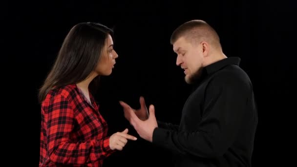 Emotional showdown between man and woman. Isolated on black background. Close up — Stock Video