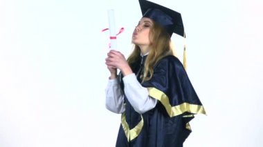 Mezunu onun diploması öpüşme yılında üniversite sonu kutluyor. Beyaz. Ağır çekim