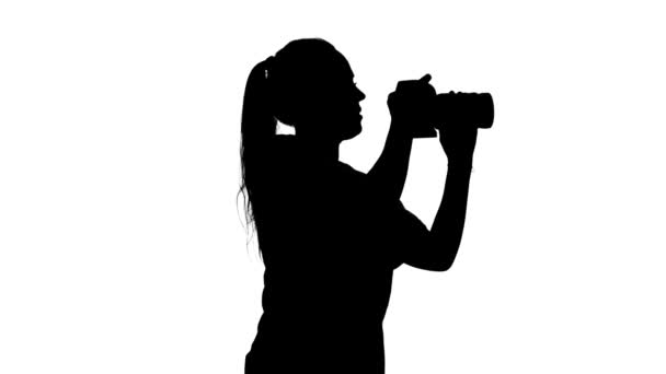 Photographer takes pictures in different sides of the studio. White. Silhouette — Stock Video