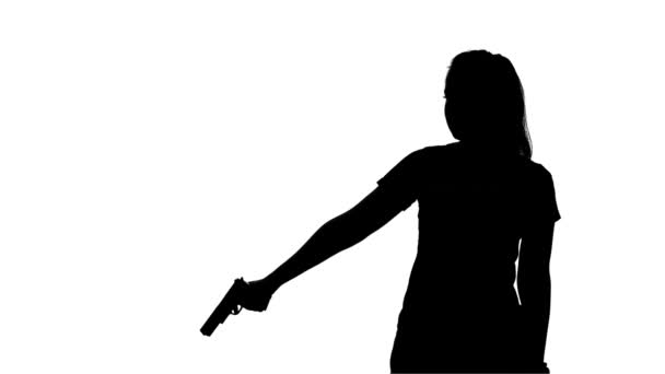 Woman pulls out from behind the gun. Silhouette. White — Stock video