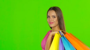 Woman holding shopping and money. Green screen. Close up