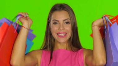 Woman had a successful shopping and smiling. Green screen. Close up