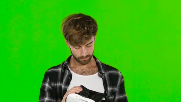 Young man with VR virtual reality headset on his head. Green screen. Close up — Stockvideo