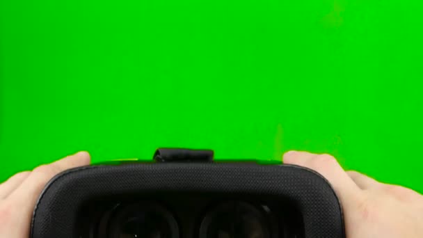 Male hand taking a virtual reality headset. Virtual reality mask. Green screen. Close up — Stock Video