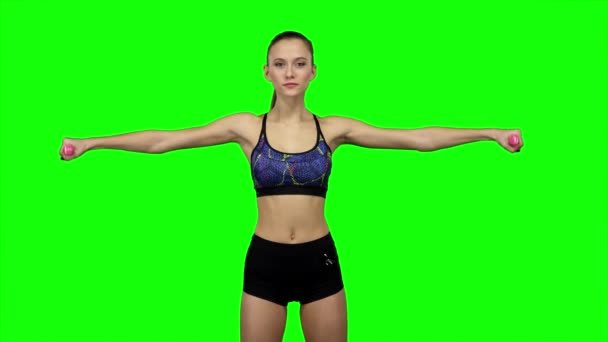 Woman doing exercises with dumbbells. Green screen — ストック動画