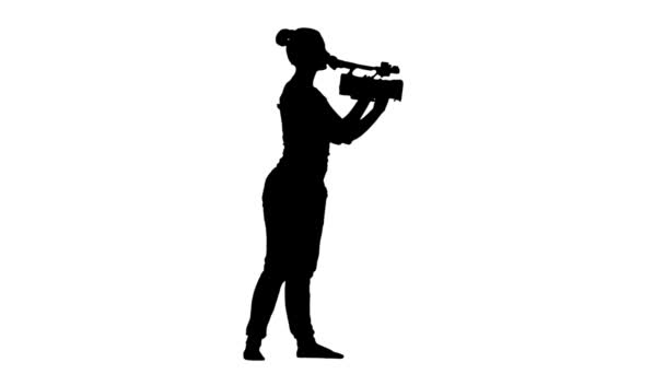 Operator makes the video camera turning. Silhouette, white background — Stock Video