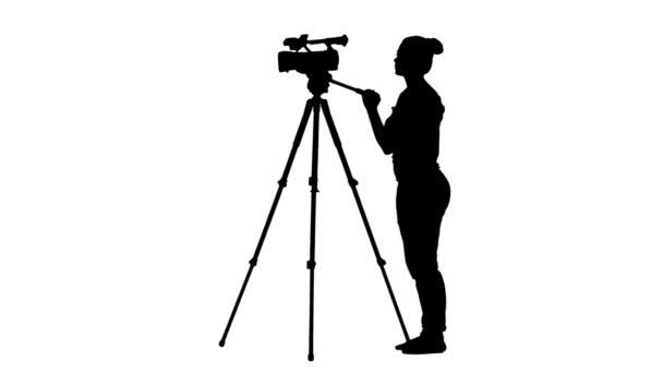 Operator works by turning camera around 180 degrees. Silhouette. White — Stock Video