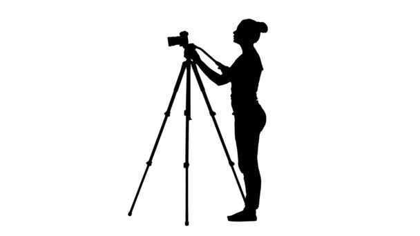 Operator standing in one place makes filming. Silhouette. White background — Stock Video