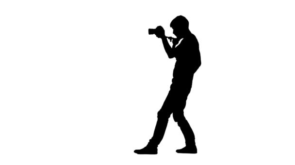 Man works in studio and makes videotaping. Silhouette. White — Stock Video