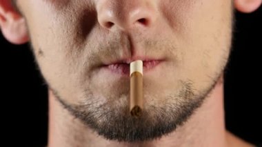 Adam bir cirarette içiyor. Siyah. Yakın çekim