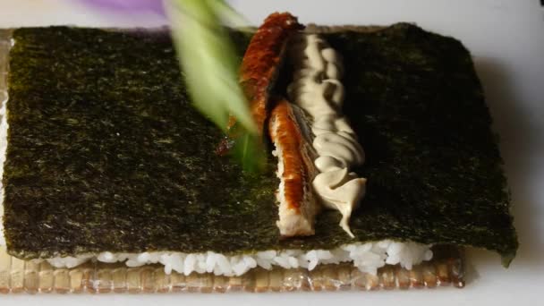 Sushi master puts a filling on a nori. Close up — Stock Video