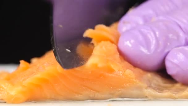 Sushi chef cuts a slice of trout. Close up — Stock Footage Sushi chef cuts a slice of trout. Close up Royalty Free Stock Footage