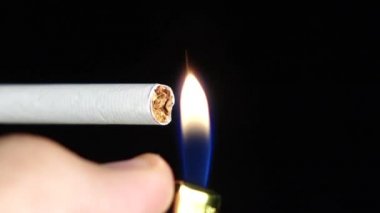 Çakmak ile hafif sigara için adam hakkında. Siyah. Yakın çekim. Ağır çekim