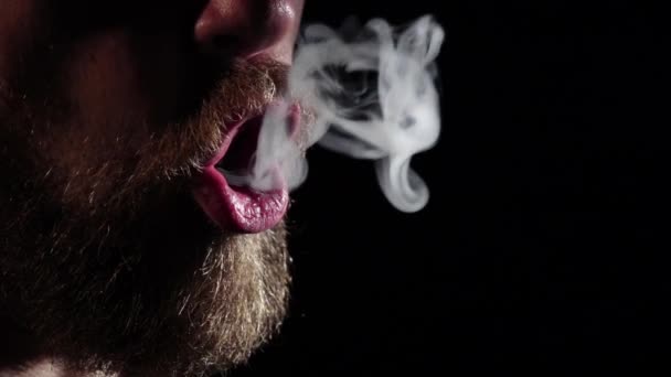 El hombre admite círculos de humo de cigarrillo. Negro. Silueta. Movimiento lento — Vídeo de stock