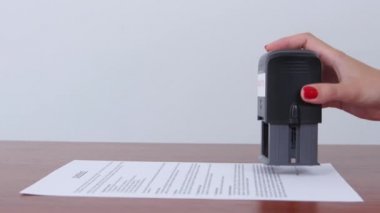 Woman enters into a contract providing assurance on the document. Close up