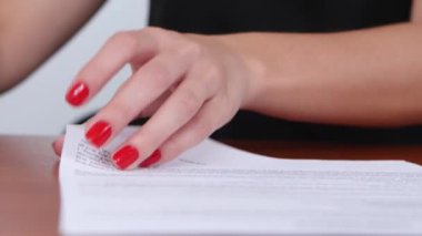 Woman was satisfied with the terms of the contract and puts the stamp. Close up