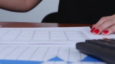 Woman certifies the accounting of company by stamp. Close up