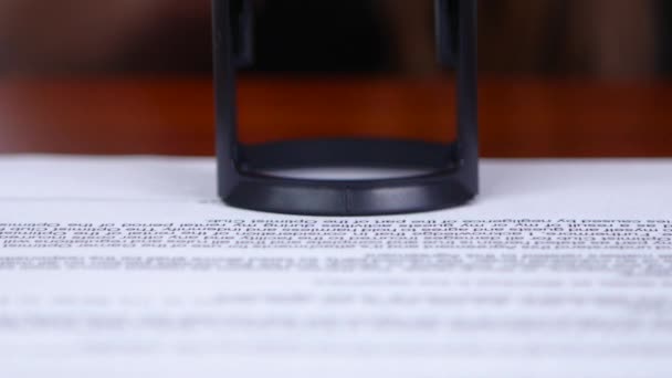 Woman puts a stamp on the document. Close up — Stock Video