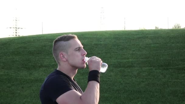Человек пьет воду после пробежки — стоковое видео