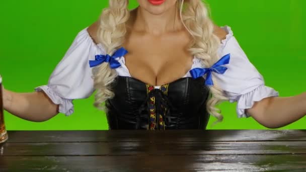 Oktoberfest. Sie stellt zwei Biergläser auf einen Holztisch. Green Screen — Stockvideo