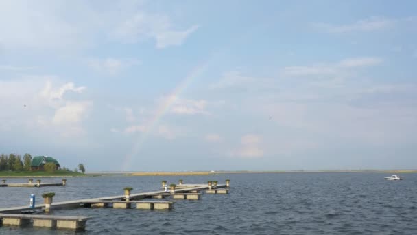 Rainbow over river and sailing boat — Stock Video