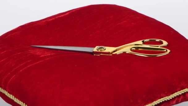 Golden scissors on red pillow — Stock Video