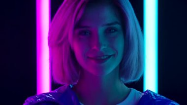 Kameraya bakıp gülümseyen şık bir kadının portresi. Kapatın. Yavaş çekim.