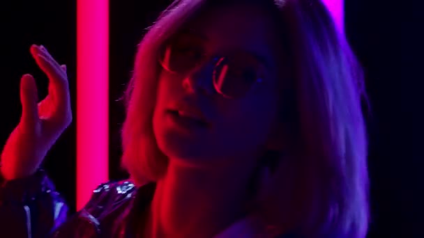 Portrait of a young stylish woman in sunglasses dancing and chewing gum. Close up. Slow motion. — Stock Video