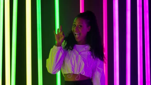 Portrait of a young lovely female African American looking at the camera and showing thumbs up and ok. Slow motion. — Stock Video