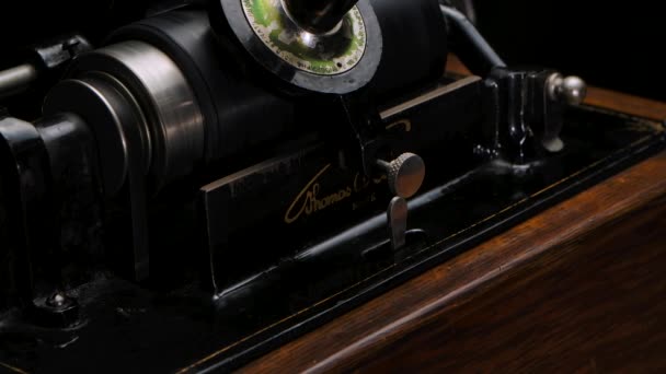 Macro detailed filming Classic Edison Phonograph plays music on a black studio background. Retro vintage machine to reproduce sound making listening to music. Close up. Slow motion. — Stock Video