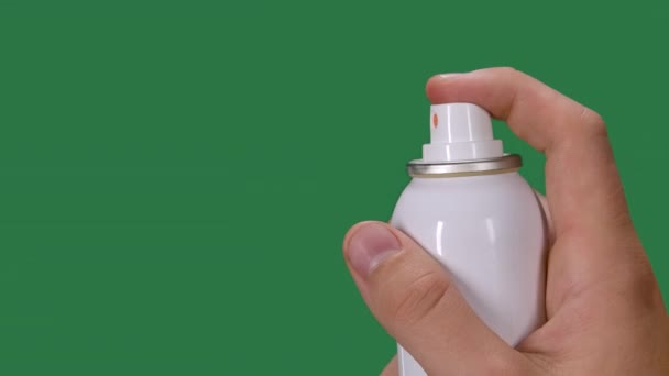 Mans hand sprays disinfectant aerosol spray. Coronovirus protection and prevention. Preventing a pandemic Covid 2019. Green screen, chroma key. Slow motion. Close up. — Stock Video
