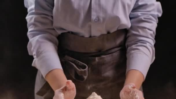 Le mani dei panettieri donna stanno versando farina naturale bianca. La donna prende le mani piene di farina e poi la riversa sul tavolo. Processo di cottura della pasta fatta in casa. Chiudete. Rallentatore. — Video Stock