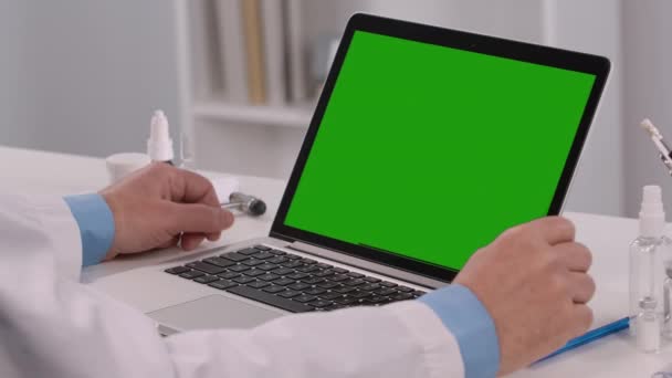 Green screen chroma key laptop concept: online remote distance examination diagnosis by video call conference chat. Man doctor consults patient explain treatment by webcam. Close up. Slow motion. — Stock Video