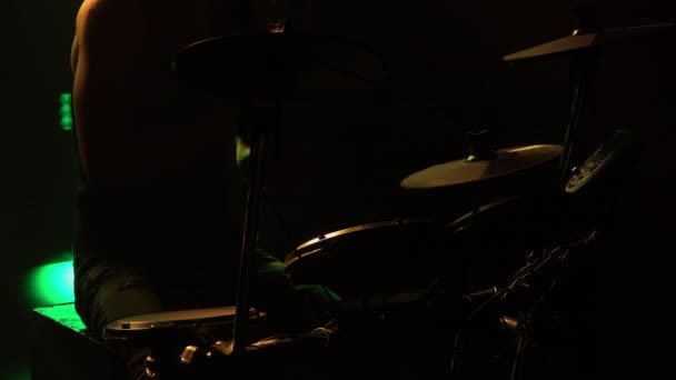 Professionell musiker spelar trummor och slagverk cymbaler i en mörk rökig studio med gult ljus. Närbild av trummisen torso pounds på trumset. Rockkonsert, live-föreställning. Silhuett. — Stockvideo