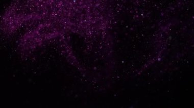 Pembe ışıkta siyah bir arkaplanda güzel bir ışıltı. Yavaş çekim.