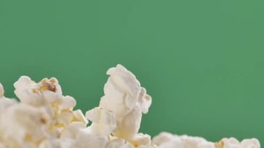 Fresh popcorn falls on top of a pile Isolated on ChromaKey Background