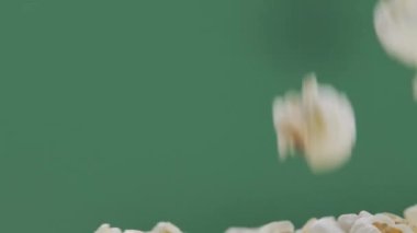 Fresh popcorn falls on top of a pile Isolated on ChromaKey Background