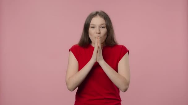 Portrait of fashion model looking at camera with a wow surprised and delighted expression. Young girl in red t-shirt posing on pink studio background. Close up. Slow motion ready 59.94fps. — Stock Video