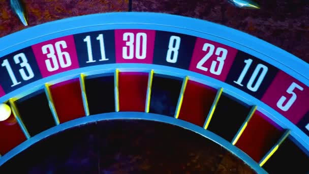 Top view of part of gambling roulette in casino with white ball on 27 red. The roulette wheel spins in slow motion, close up numbers. Gambling, betting, chance to win. — Stock Video