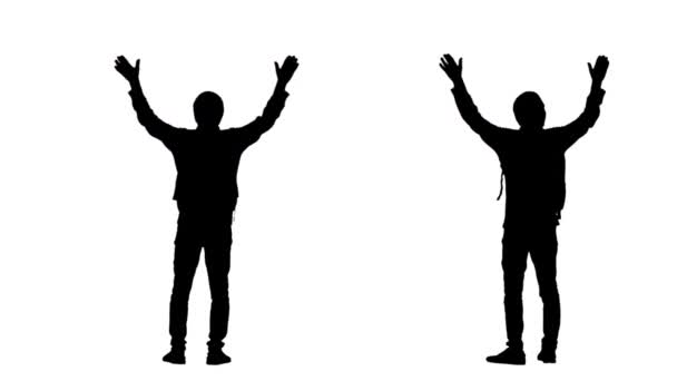 Black silhouette of a young man in sportswear with a backpack, rejoices at what he saw raising his hands up. 2 in 1 Collage back view full length on white background. Slow motion ready 59.94fps. — Stock Video