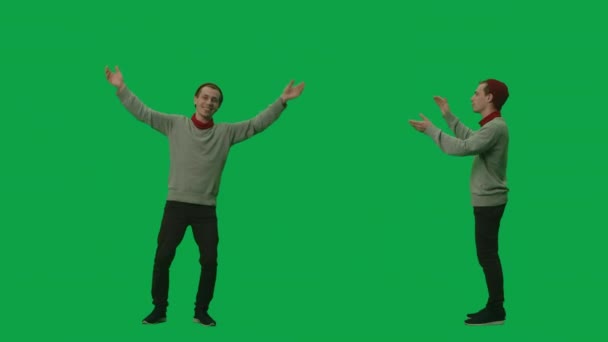 Portrait of young man in youth stylish clothes and hat is dancing and claps her hands. 2 in 1 Collage Front and side view full length on green screen background. Slow motion ready, 4K at 59.94fps. — Stock Video