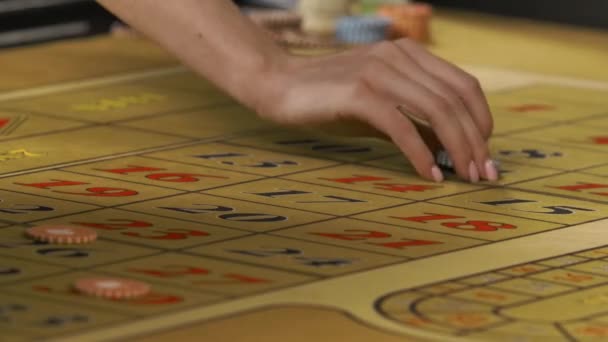 Men and women betting in the casino. Gamblers place game chips on red and black numbers on the roulette table. Glamorous party in gambling club. Hands close up. Slow motion ready, 4K at 59.94fps. — Stock Video